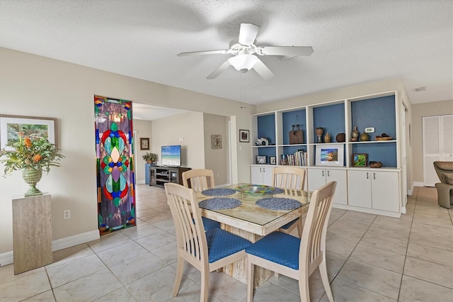 tiled dining room featuring ceiling fan and a textured ceiling