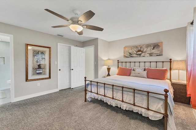 carpeted bedroom with ceiling fan and ensuite bathroom