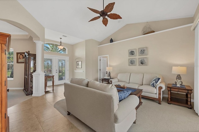 living room with decorative columns, vaulted ceiling, plenty of natural light, and french doors