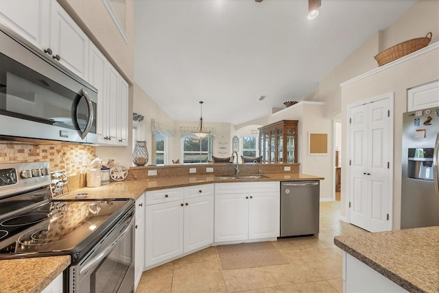 kitchen featuring appliances with stainless steel finishes, decorative light fixtures, white cabinetry, sink, and backsplash