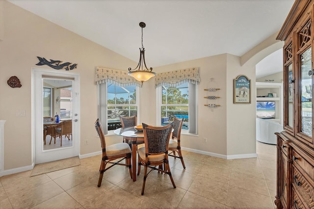 tiled dining area with vaulted ceiling