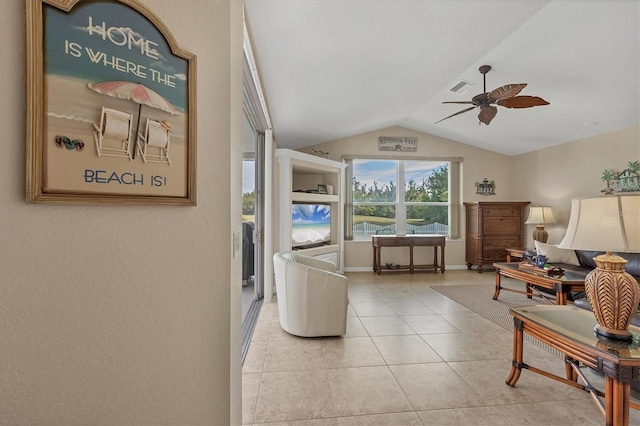 living area with lofted ceiling, light tile patterned floors, and ceiling fan