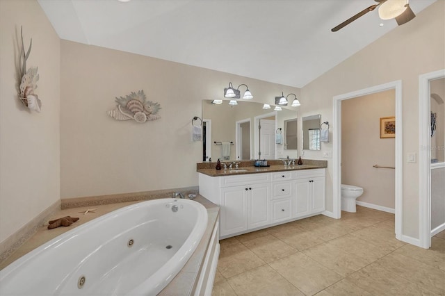 bathroom featuring lofted ceiling, vanity, tile patterned floors, toilet, and a bathing tub