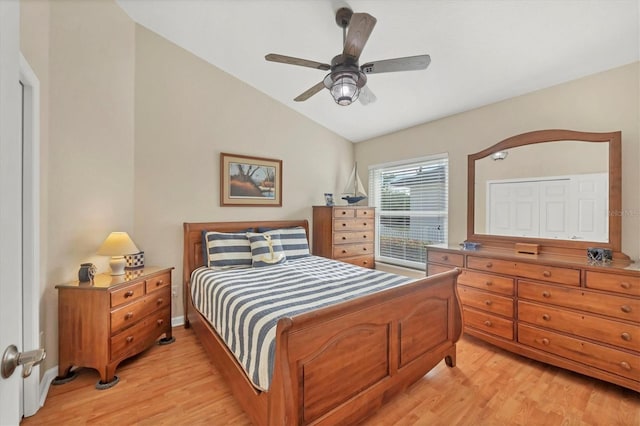 bedroom featuring ceiling fan, lofted ceiling, and light wood-type flooring