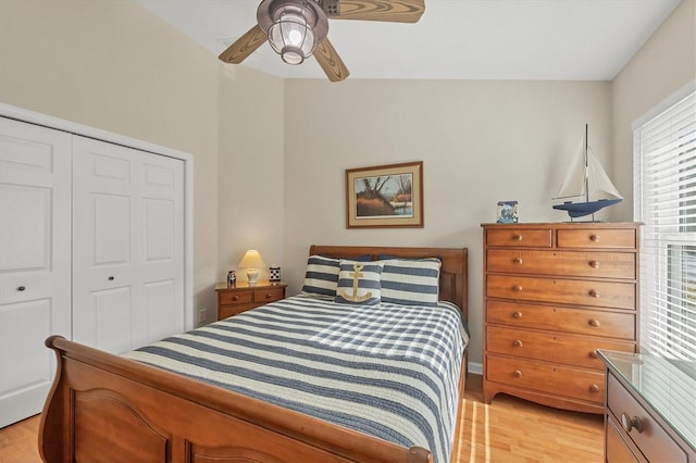 bedroom featuring ceiling fan, light hardwood / wood-style floors, and a closet