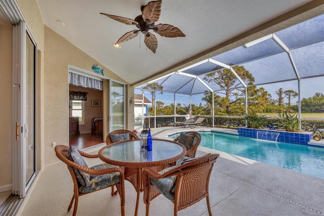 view of swimming pool featuring a lanai, a patio area, pool water feature, and ceiling fan