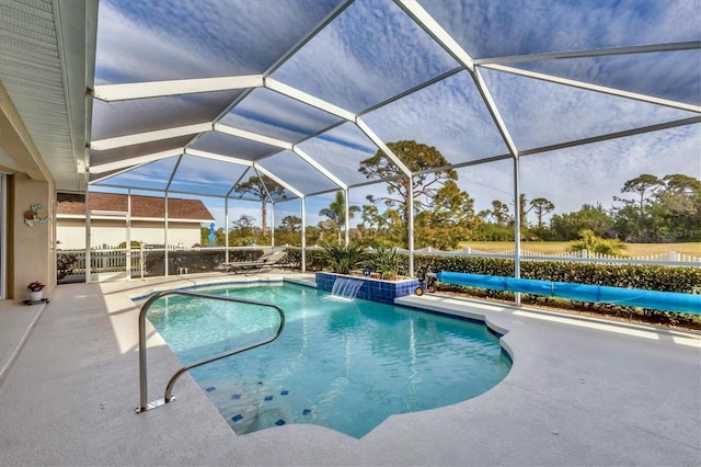 view of pool featuring pool water feature, a lanai, and a patio