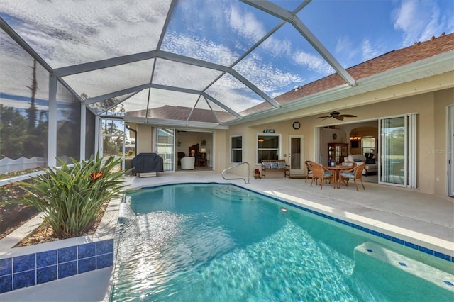 view of swimming pool featuring a grill, a patio area, ceiling fan, and glass enclosure