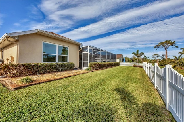 view of yard with glass enclosure