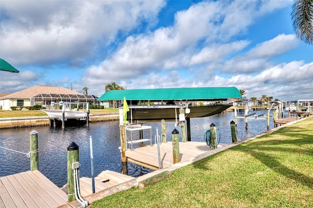 dock area with a water view and a lawn