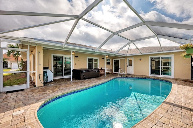 view of swimming pool featuring a lanai, a patio area, and a hot tub