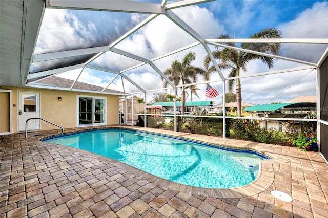 view of pool with a patio area and a lanai