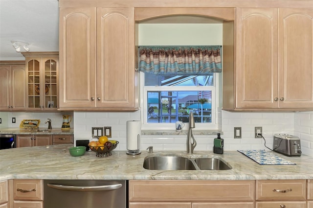 kitchen with light brown cabinetry, sink, dishwasher, and tasteful backsplash