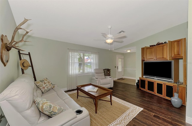 living room featuring ceiling fan and dark hardwood / wood-style floors