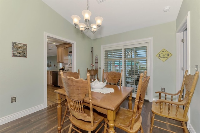 dining room with dark hardwood / wood-style flooring, a chandelier, and vaulted ceiling