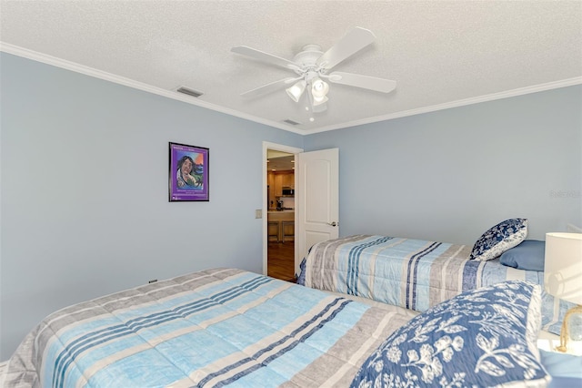 bedroom featuring ceiling fan, crown molding, and a textured ceiling