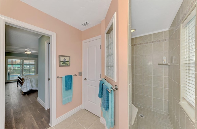 bathroom featuring tile patterned floors and tiled shower