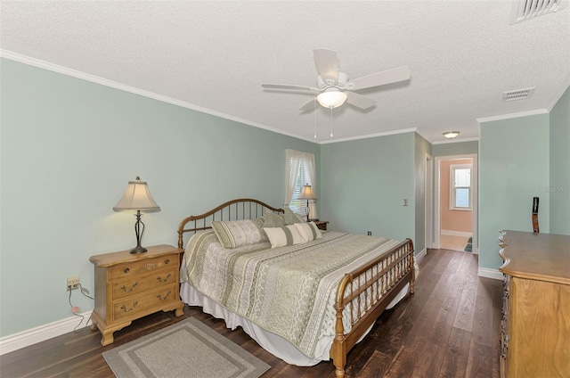 bedroom with ceiling fan, dark hardwood / wood-style flooring, ornamental molding, and a textured ceiling