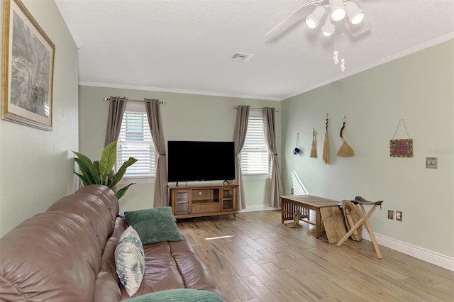 living room with a textured ceiling, ceiling fan, crown molding, and light hardwood / wood-style flooring