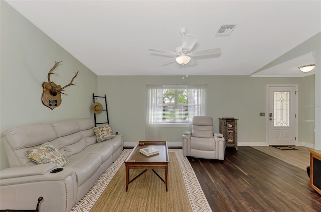 living area with visible vents, a ceiling fan, dark wood-style floors, and baseboards