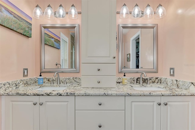 full bathroom featuring double vanity and a sink