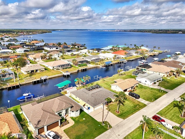drone / aerial view with a residential view and a water view