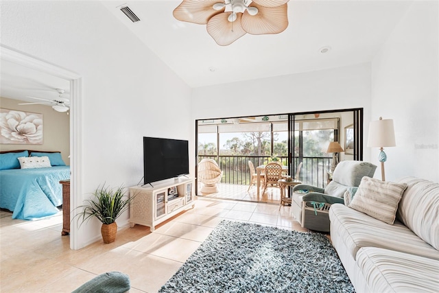 tiled living room with ceiling fan and high vaulted ceiling