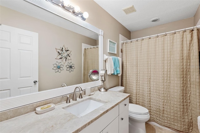 bathroom with toilet, a textured ceiling, and vanity