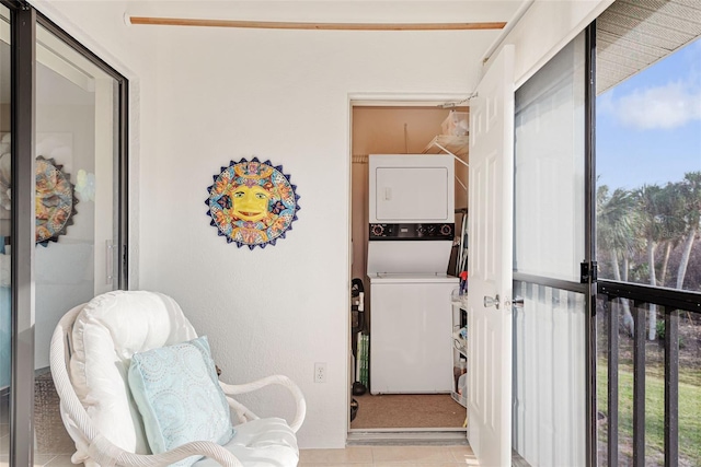 interior space featuring light tile patterned floors and stacked washer and clothes dryer