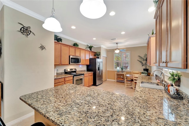 kitchen featuring appliances with stainless steel finishes, kitchen peninsula, sink, and hanging light fixtures