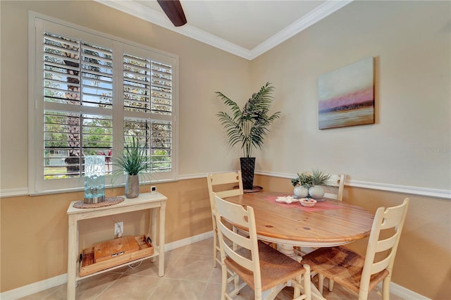 dining room featuring tile patterned flooring and crown molding