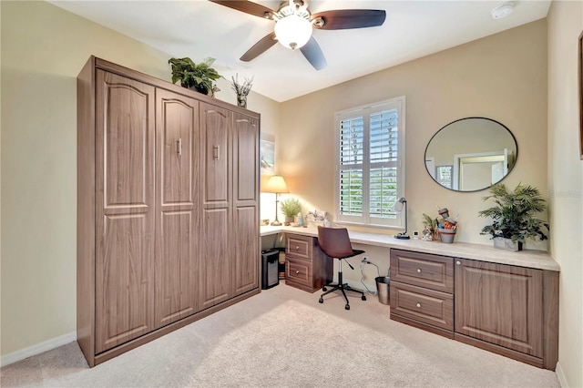 carpeted office featuring ceiling fan