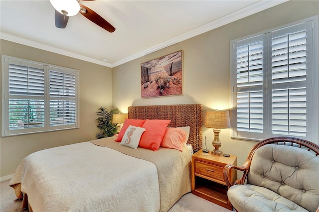 bedroom featuring ornamental molding, light colored carpet, and ceiling fan