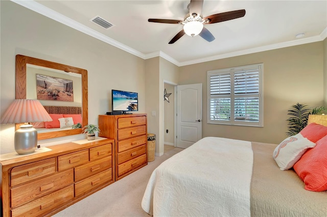 bedroom with crown molding, ceiling fan, and carpet flooring