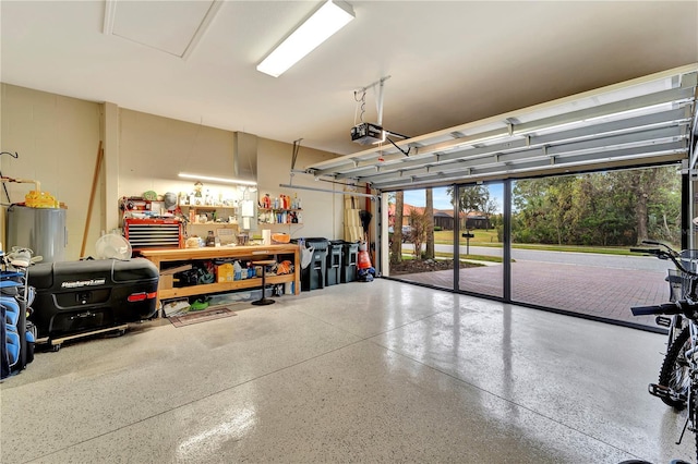 garage with water heater, a garage door opener, and a workshop area