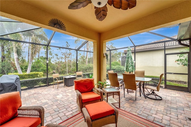 sunroom featuring ceiling fan