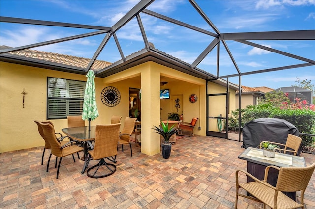 view of patio with a lanai and a grill