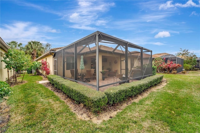 back of property featuring a lanai, a patio area, and a lawn