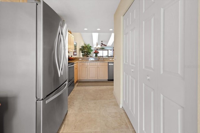 kitchen featuring appliances with stainless steel finishes, light brown cabinetry, and sink