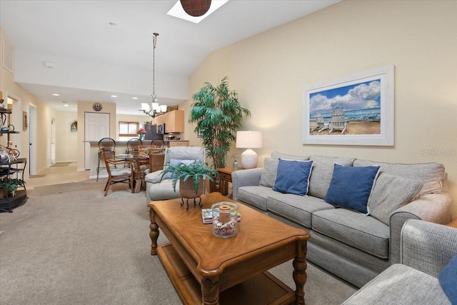 living room featuring lofted ceiling, light carpet, and a chandelier