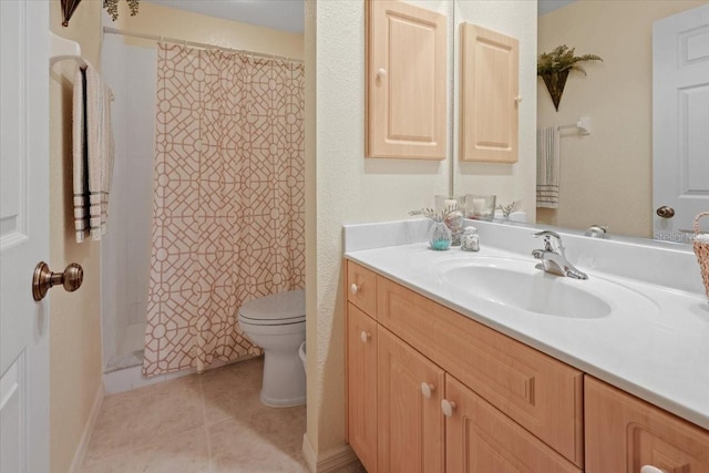 bathroom with toilet, tile patterned floors, and vanity