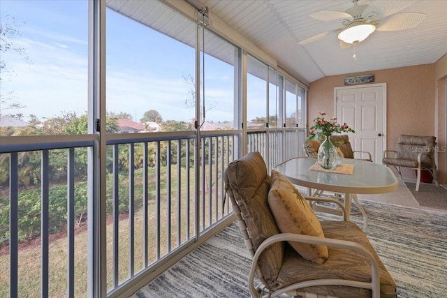 sunroom / solarium with ceiling fan and vaulted ceiling