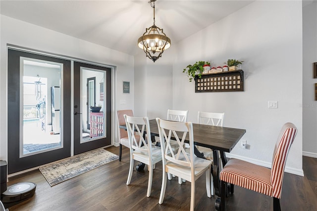 dining space with french doors, dark hardwood / wood-style flooring, and a notable chandelier