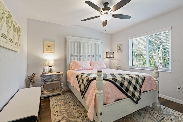 bedroom featuring dark hardwood / wood-style floors and ceiling fan