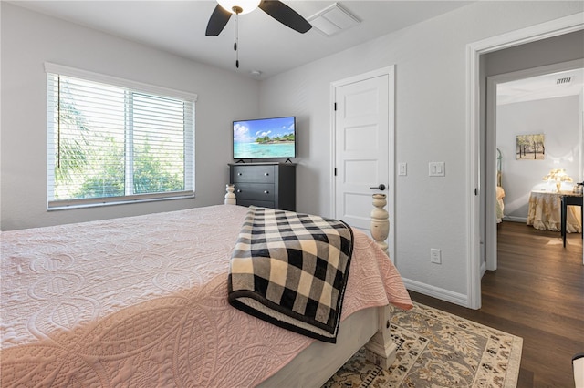 bedroom with ceiling fan and dark hardwood / wood-style floors