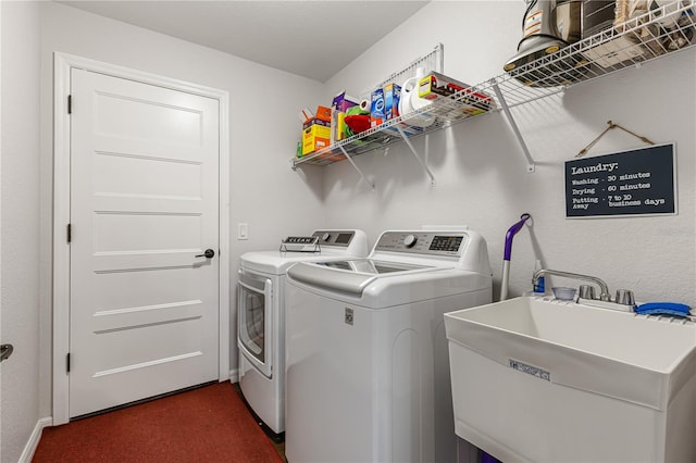 laundry area with washing machine and dryer and sink