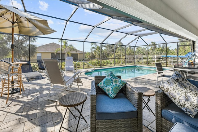 view of swimming pool featuring a patio and glass enclosure