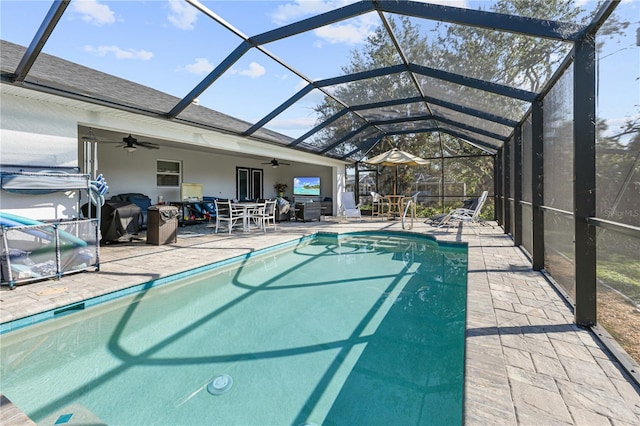 view of swimming pool with a lanai, a patio, and ceiling fan