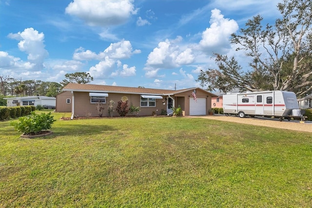 single story home featuring a front yard and a garage