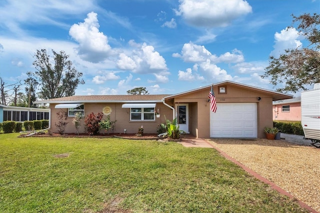 ranch-style house featuring a front lawn and a garage